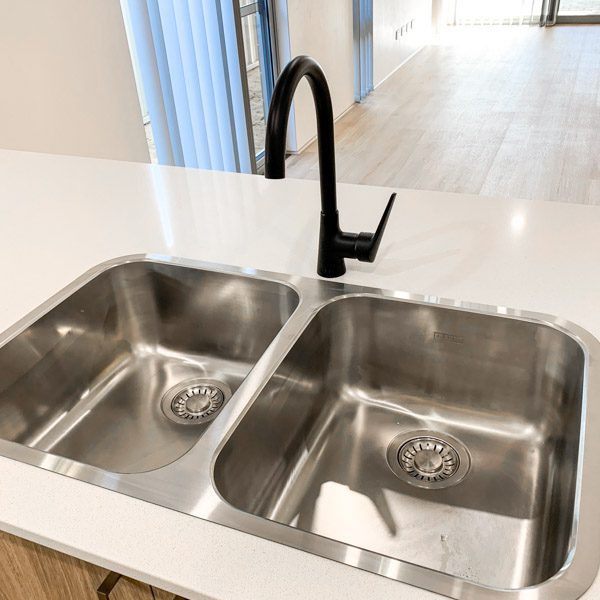Double kitchen sink with matte black tap