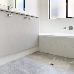 grey bathroom tiles with grey shelves