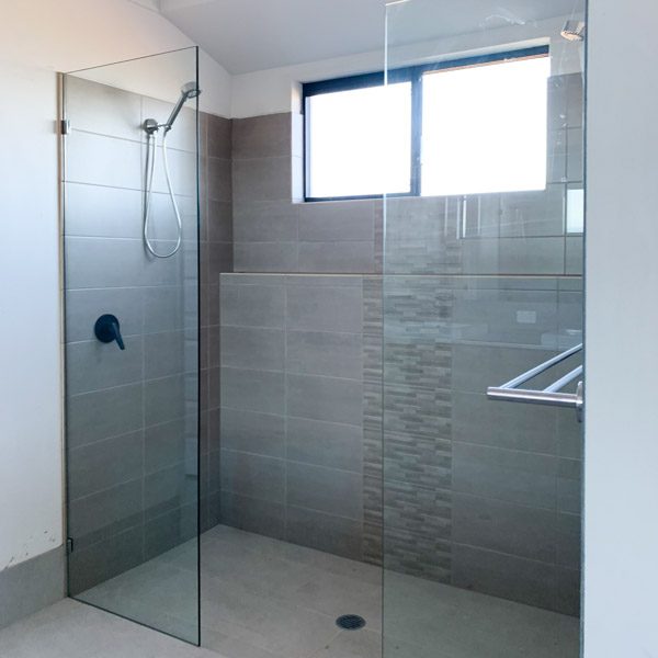 brand new bathroom with glass on shower
