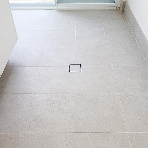 Square drain in laundry by Move Homes