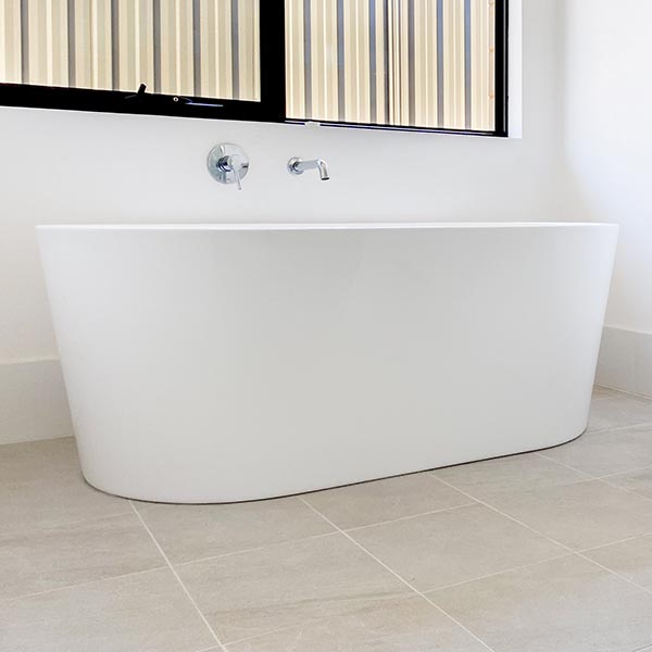 Free standing bath on Jakarta White tiles by Move Homes