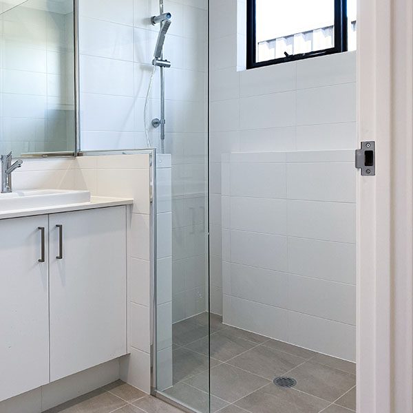 Image of a shower by Move Homes with a custom designed shelf in the shower