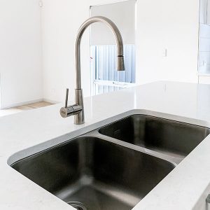 A double undermount kitchen sink in a custom home by Move Homes in Perth