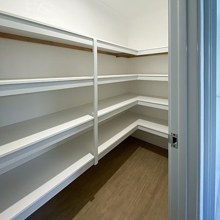 A walk-in linen cupboard creates storage in a brand new home