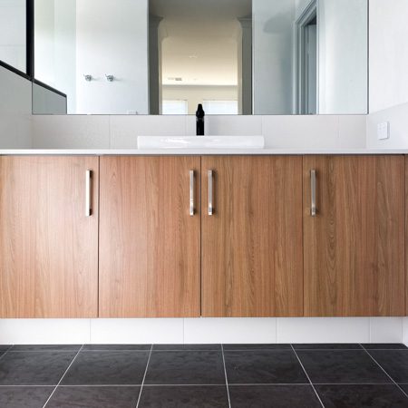 Tassie Oak cabinetry in an ensuite by Move Homes