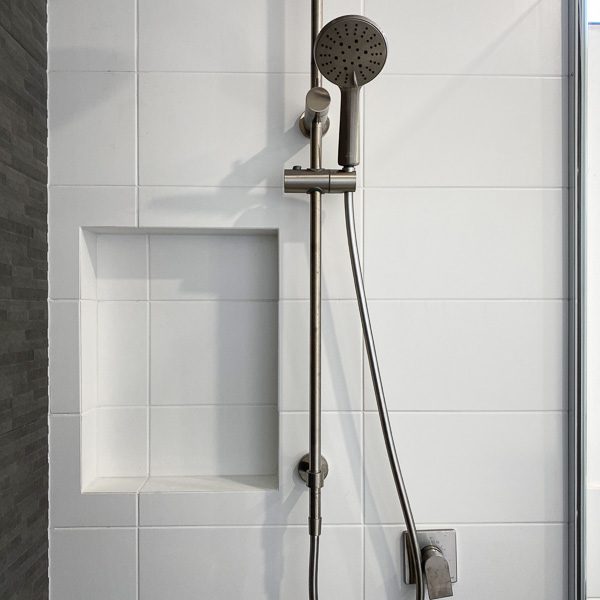 A shower niche and rail showerhead is a popular upgrade for new homes