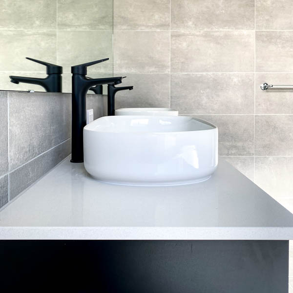 Above counter sinks in a bathroom by Move Homes
