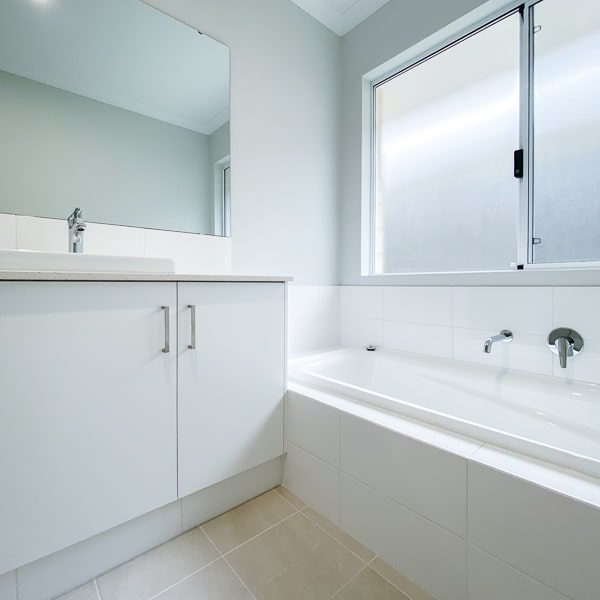 A white bathroom in a house and land package in Jindalee