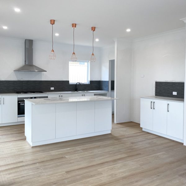 A kitchen and scullery in a new home in Baldivis by Move Homes