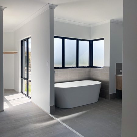 An open ensuite with a huge free-standing bath